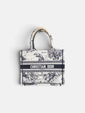 Last Season Christian Dior Book Tote in white and black canvas with intricate celestial and mythological embroidery.