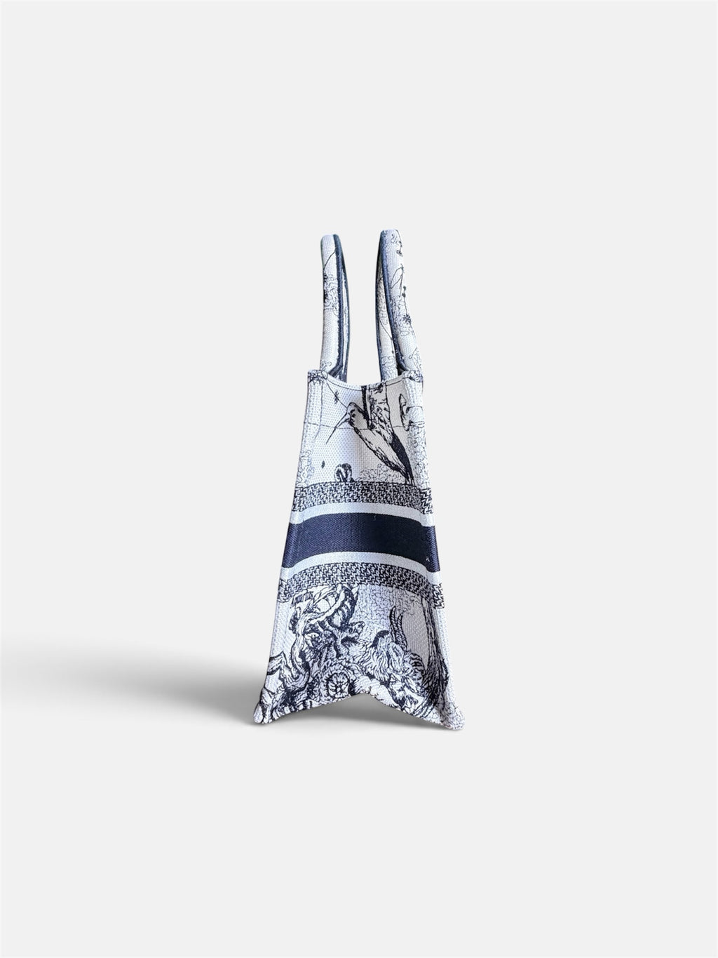 Last Season Christian Dior Book Tote in white and black canvas with intricate celestial and mythological embroidery.
