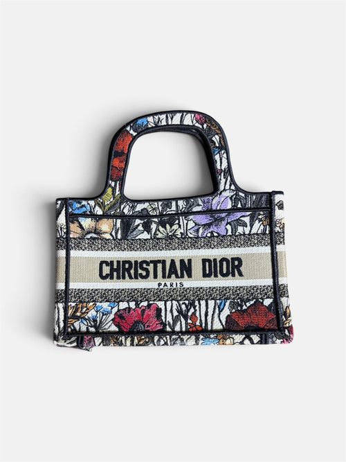 Last Season CHRISTIAN DIOR mini tote bag featuring intricate multi-colored floral embroidery and a central logo band.