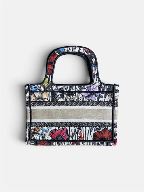 Last Season CHRISTIAN DIOR mini tote bag featuring intricate multi-colored floral embroidery and a central stripe band.