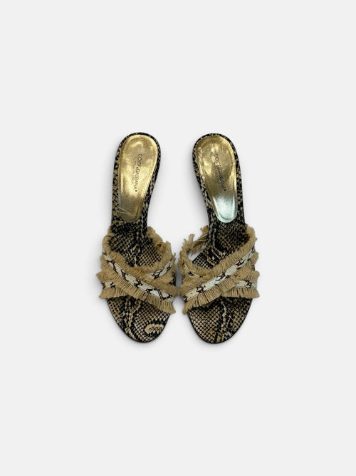 Last Season Dolce & Gabbana high heel mules in snakeskin print with crossover straps and frayed fringe detailing.
