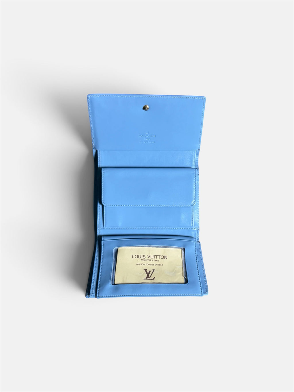 Last Season blue patent leather Louis Vuitton wallet with embossed monogram, card slots, and ID window, open view.